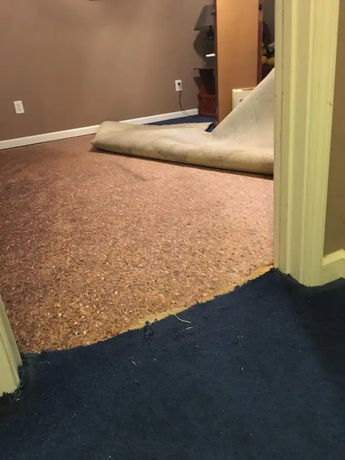 Carpet pad removal revealing water damage during Water Mitigation Services in Green River